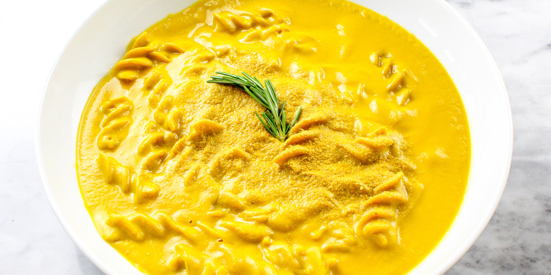 White Corn Fusilloni with Turmeric and Sarawak Pepper in a Creamy Carrot Soup with Rosemary